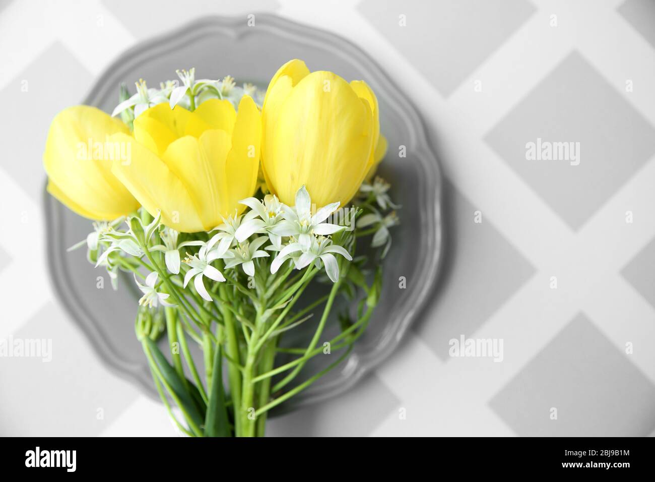 Bouquet of flowers on gray plate Stock Photo