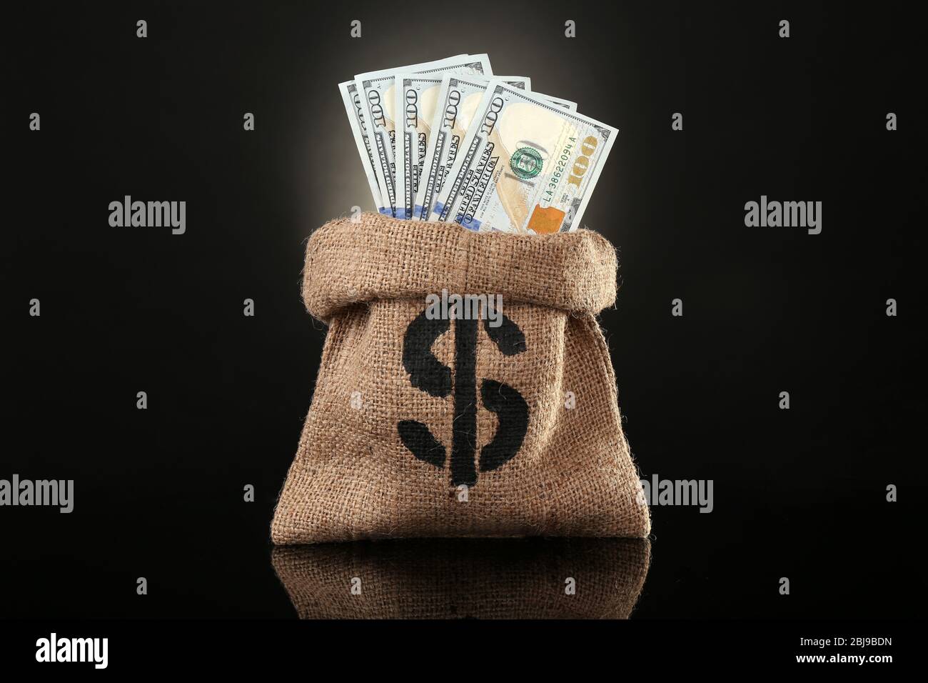 Money Bag With Dollars On Black Background Stock Photo Alamy