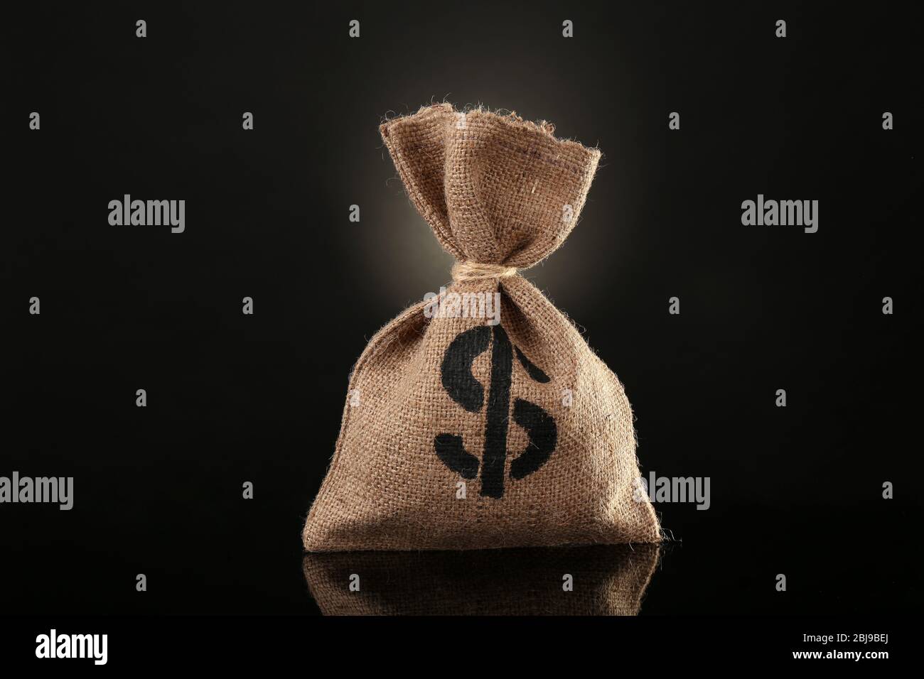 Money bag on black background Stock Photo - Alamy