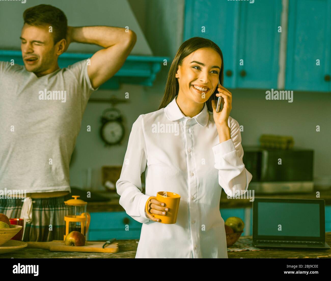 Morning Of Young Family In Domestic Kitchen Stock Photo