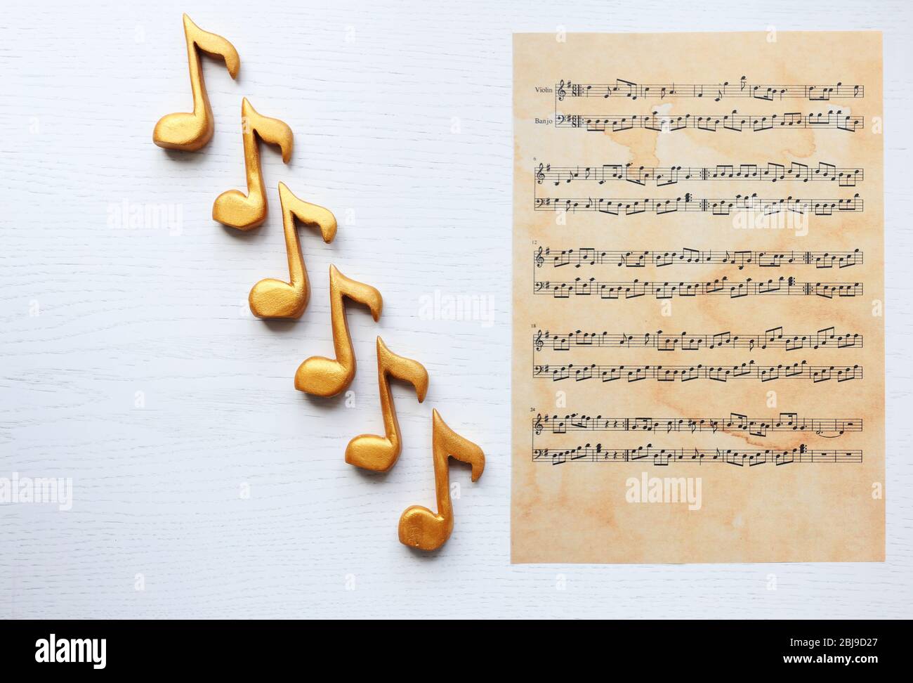 Music notes and sheet of notes on white background Stock Photo - Alamy