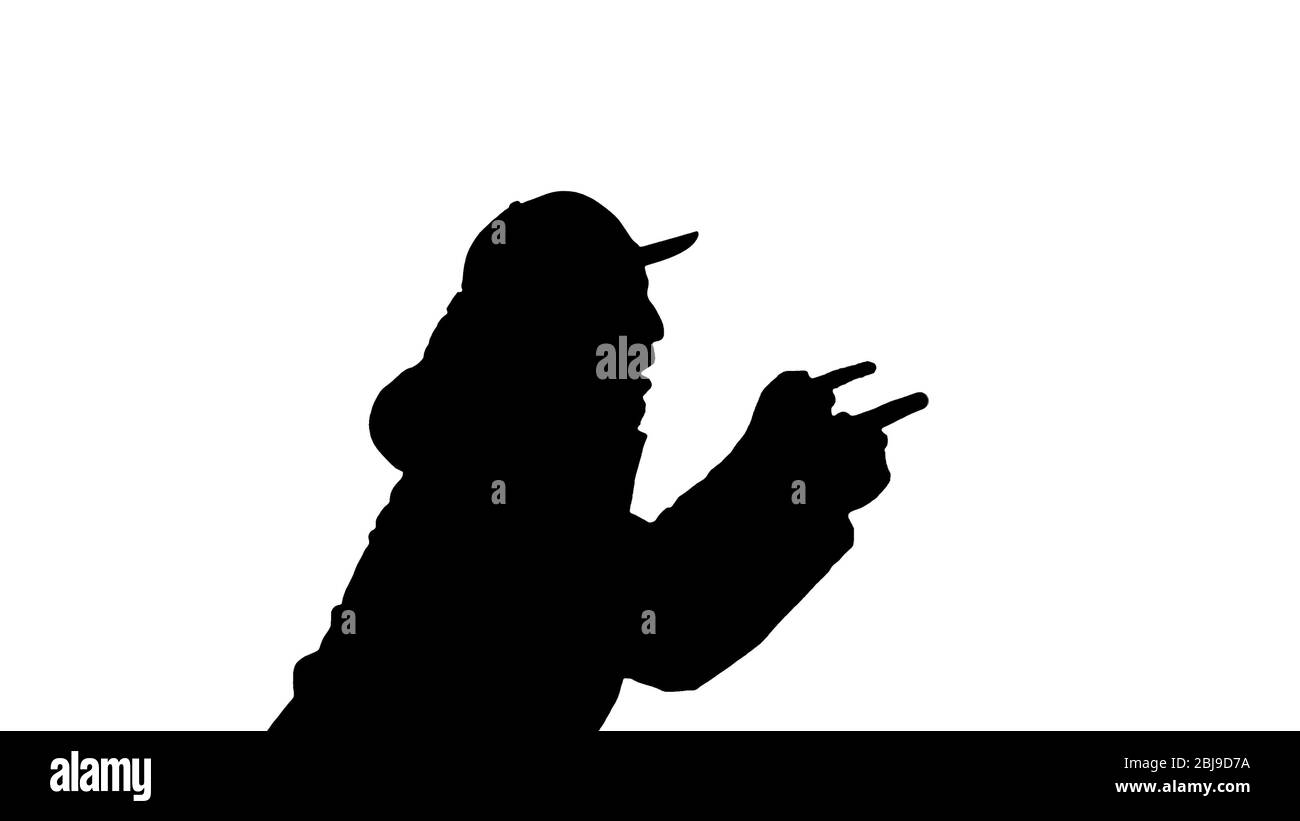 Silhouette Hip-hop man singing rap, walking and making gestures. Stock Photo