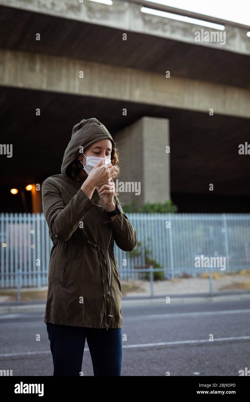 Caucasian woman wearing a protective mask in the streets Stock Photo