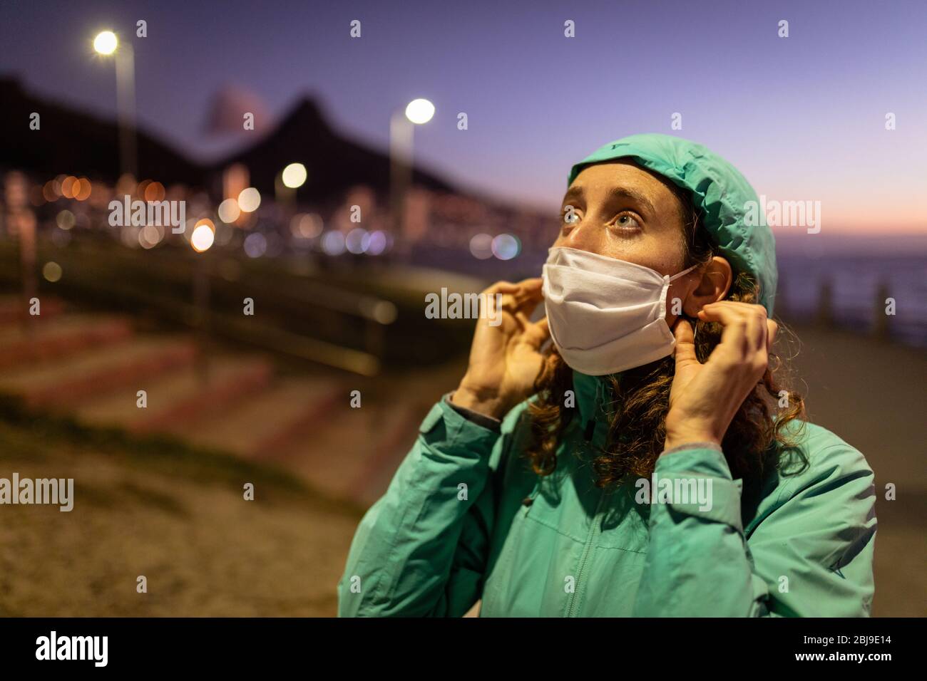 Woman putting on a mask hi-res stock photography and images - Alamy