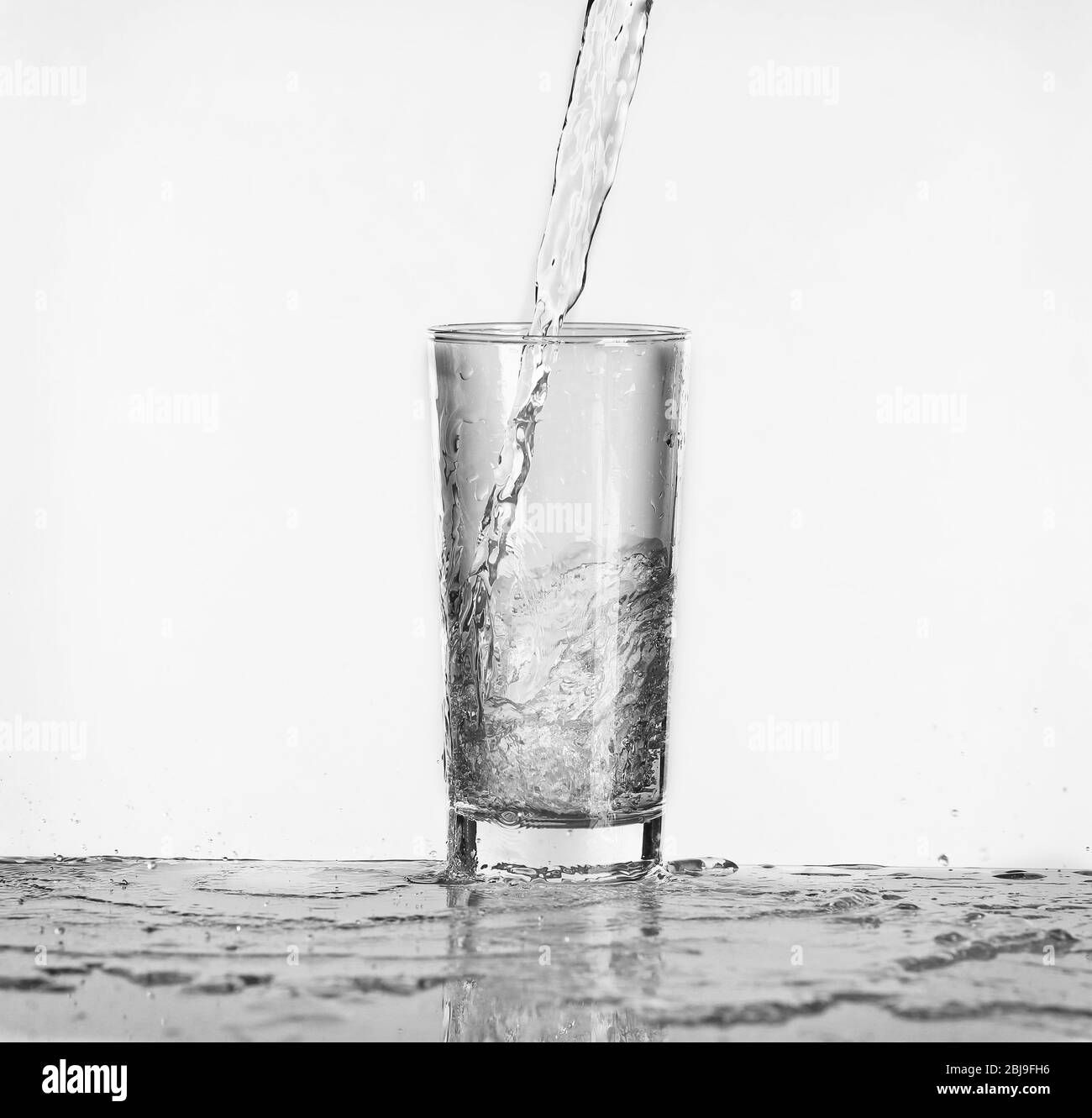 Pouring water into glass Black and White Stock Photos & Images Alamy