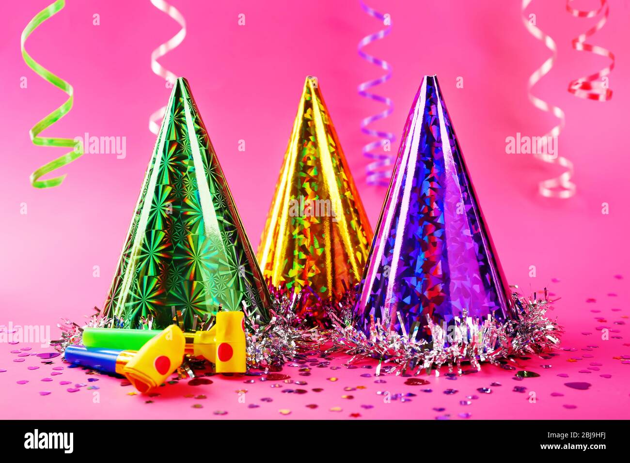 Party hats cone on pink background Stock Photo - Alamy