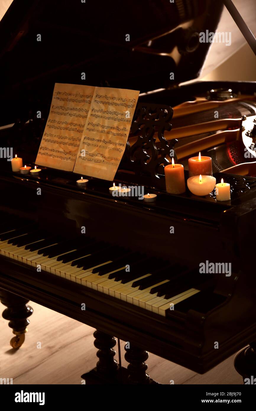 Piano with candles and music notes Stock Photo Alamy