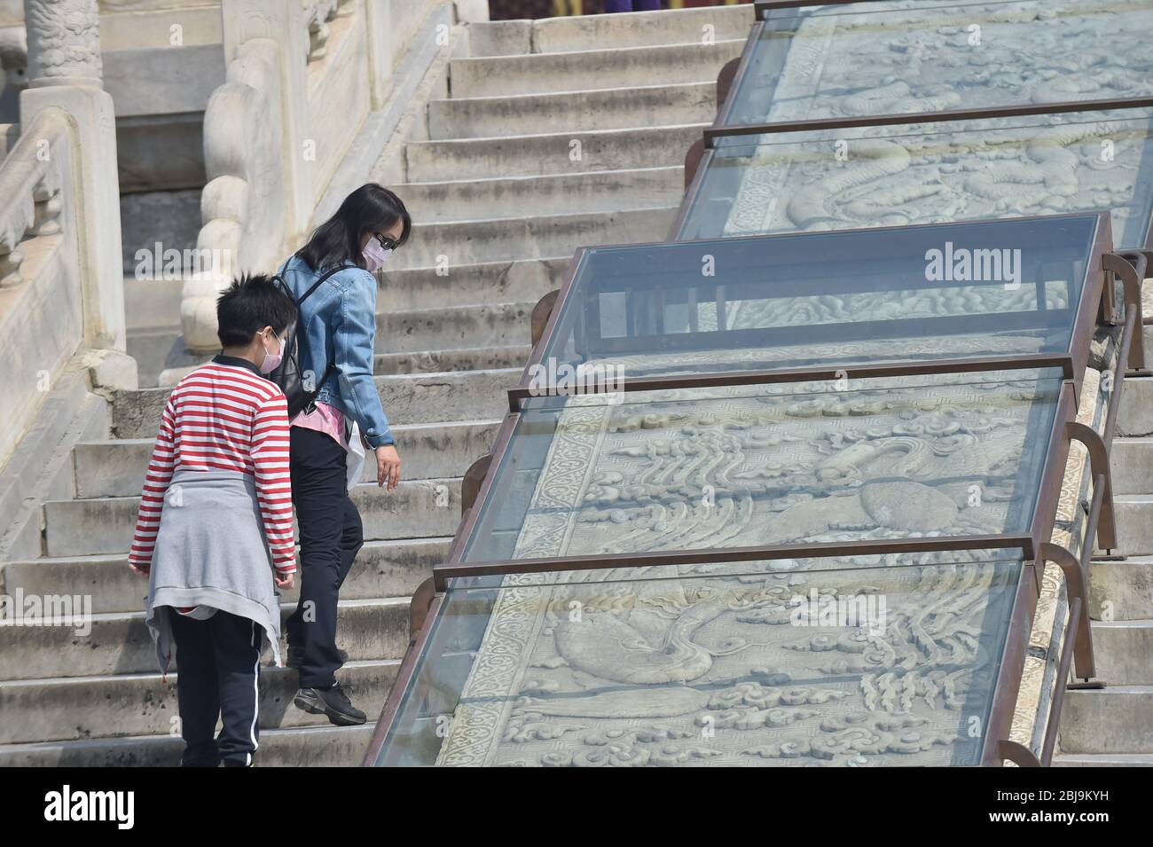 Beijing, China. 29th Apr, 2020. Tourists visit the Hall of Prayer for Good Harvests at the Temple of Heaven in Beijing, capital of China, April 29, 2020. The Temple of Heaven, a UNESCO World Heritage Site temporarily closed due to the COVID-19 outbreak, reopened its three main building groups to the public on Wednesday. The reopened grounds, namely the Hall of Prayer for Good Harvest, the Imperial Vault of Heaven and the Circular Mound Altar, can be accessed by a limited number of visitors via online booking. Credit: Peng Ziyang/Xinhua/Alamy Live News Stock Photo