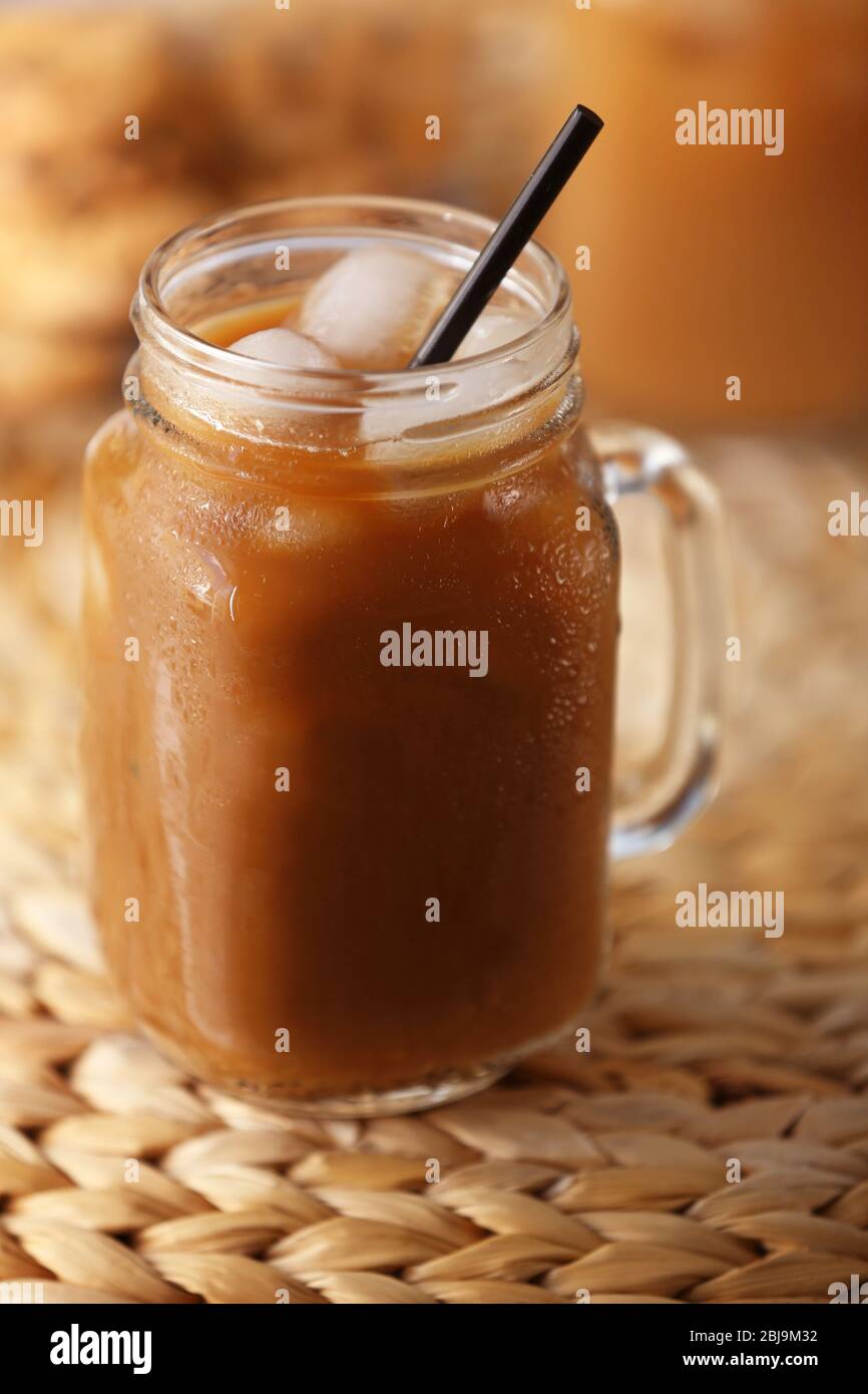 https://c8.alamy.com/comp/2BJ9M32/iced-coffee-in-glass-jar-on-wicker-table-2BJ9M32.jpg