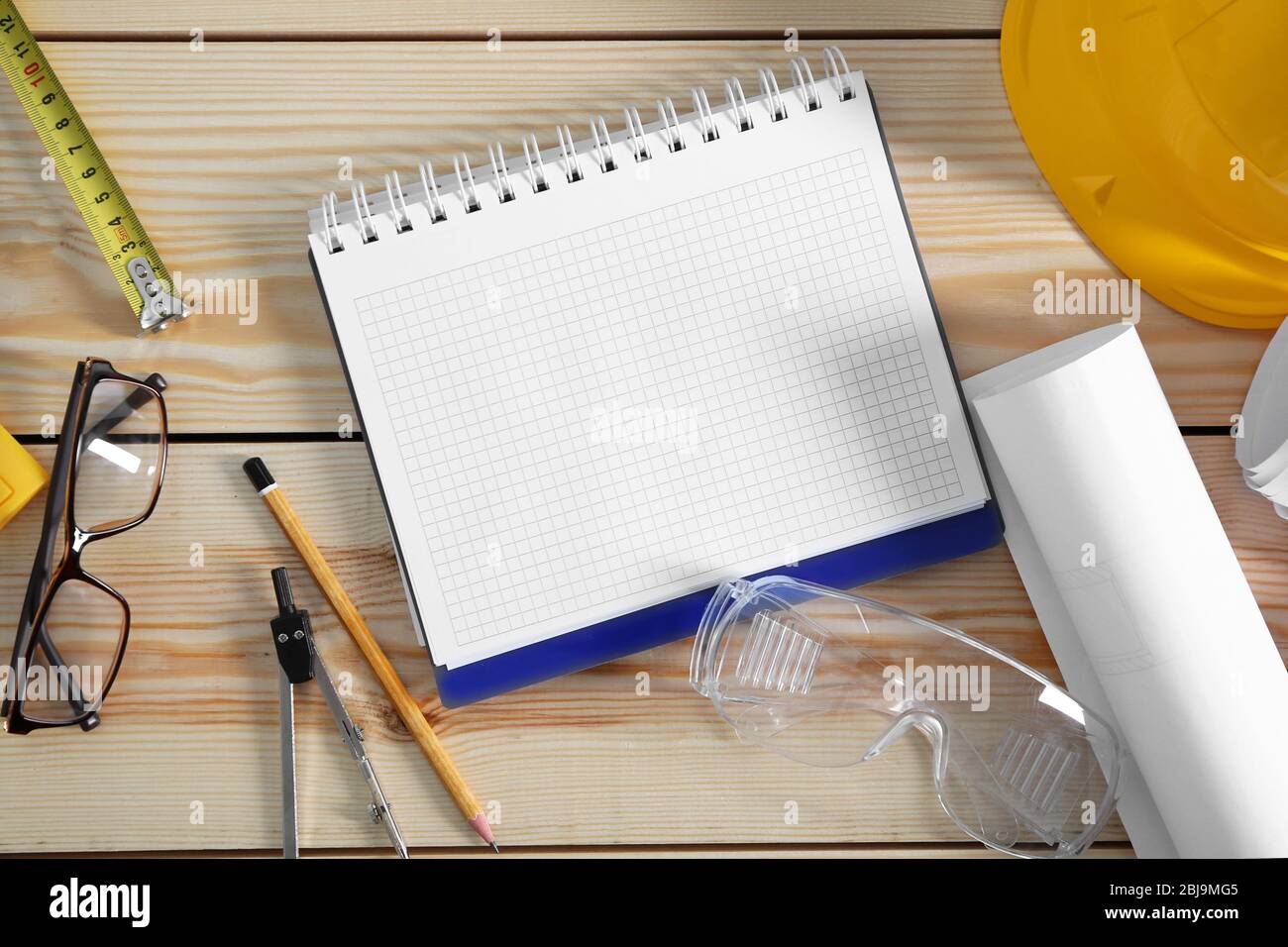 Notebook with construction tools on wooden background Stock Photo Alamy