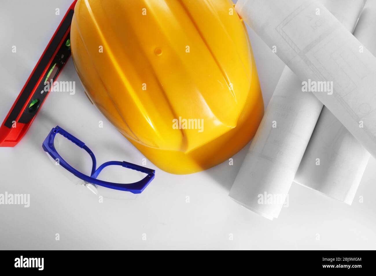 Construction drawings with tools and helmet, top view Stock Photo
