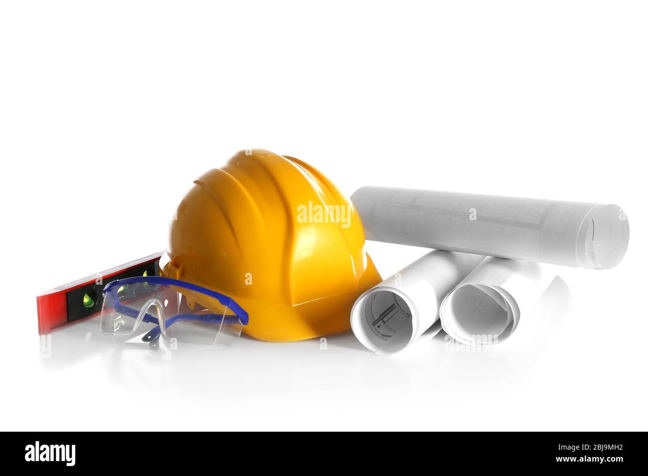 Construction drawings with tools and helmet isolated on white Stock Photo