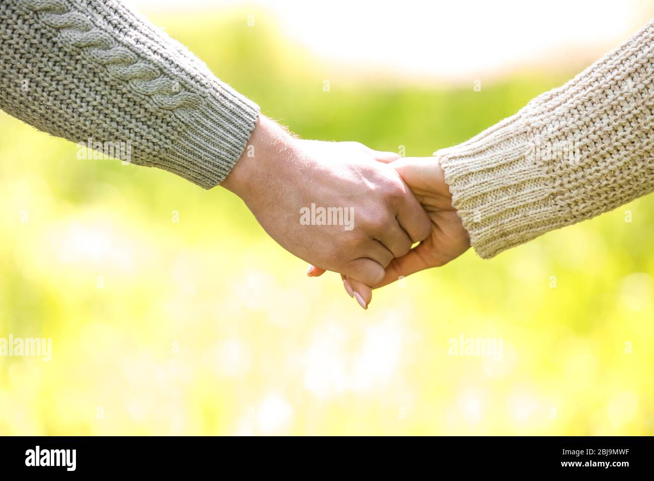 Lovely couple hands in park Stock Photo - Alamy