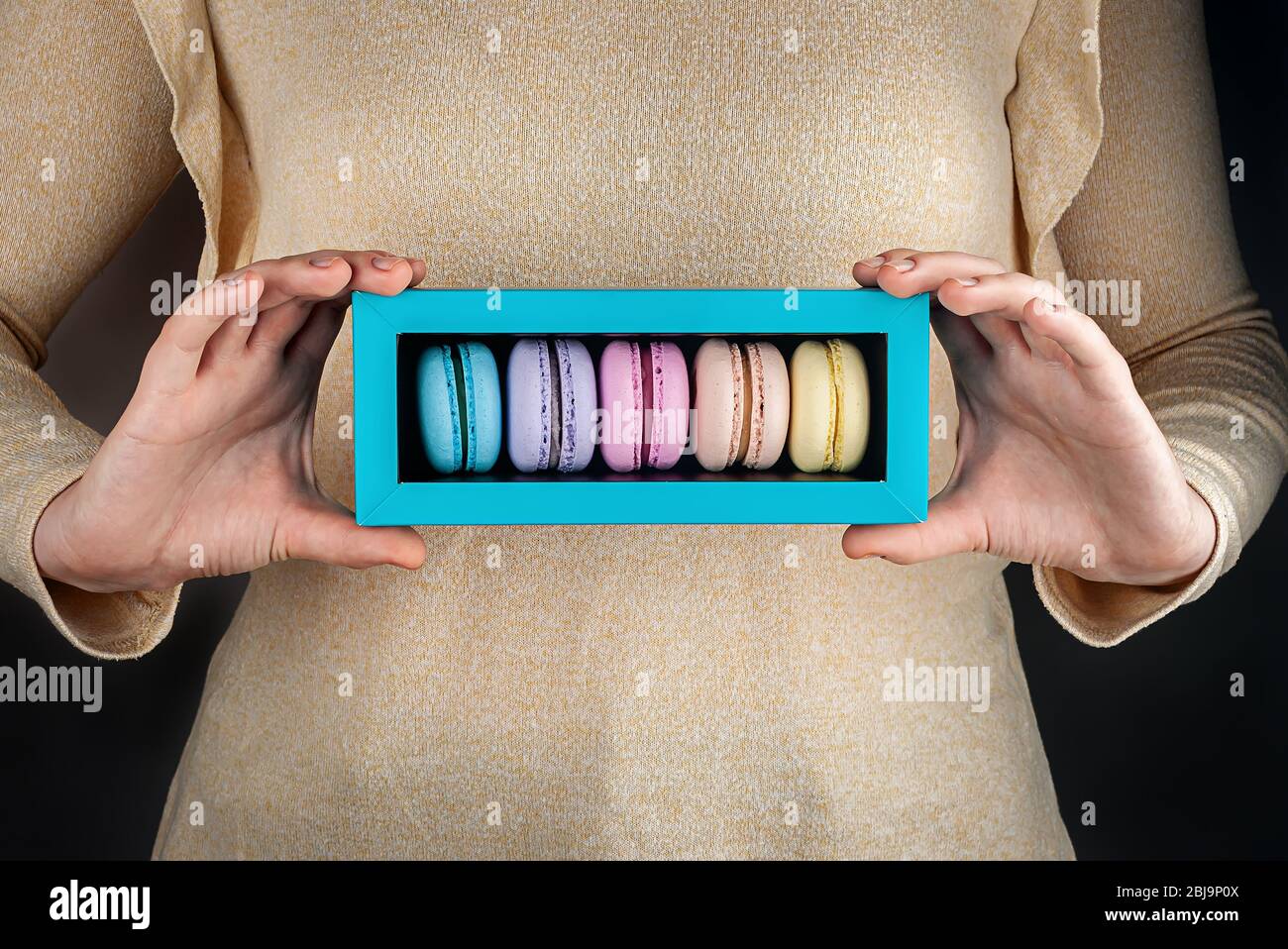 Girl hold colorful macaroons in gift box Stock Photo