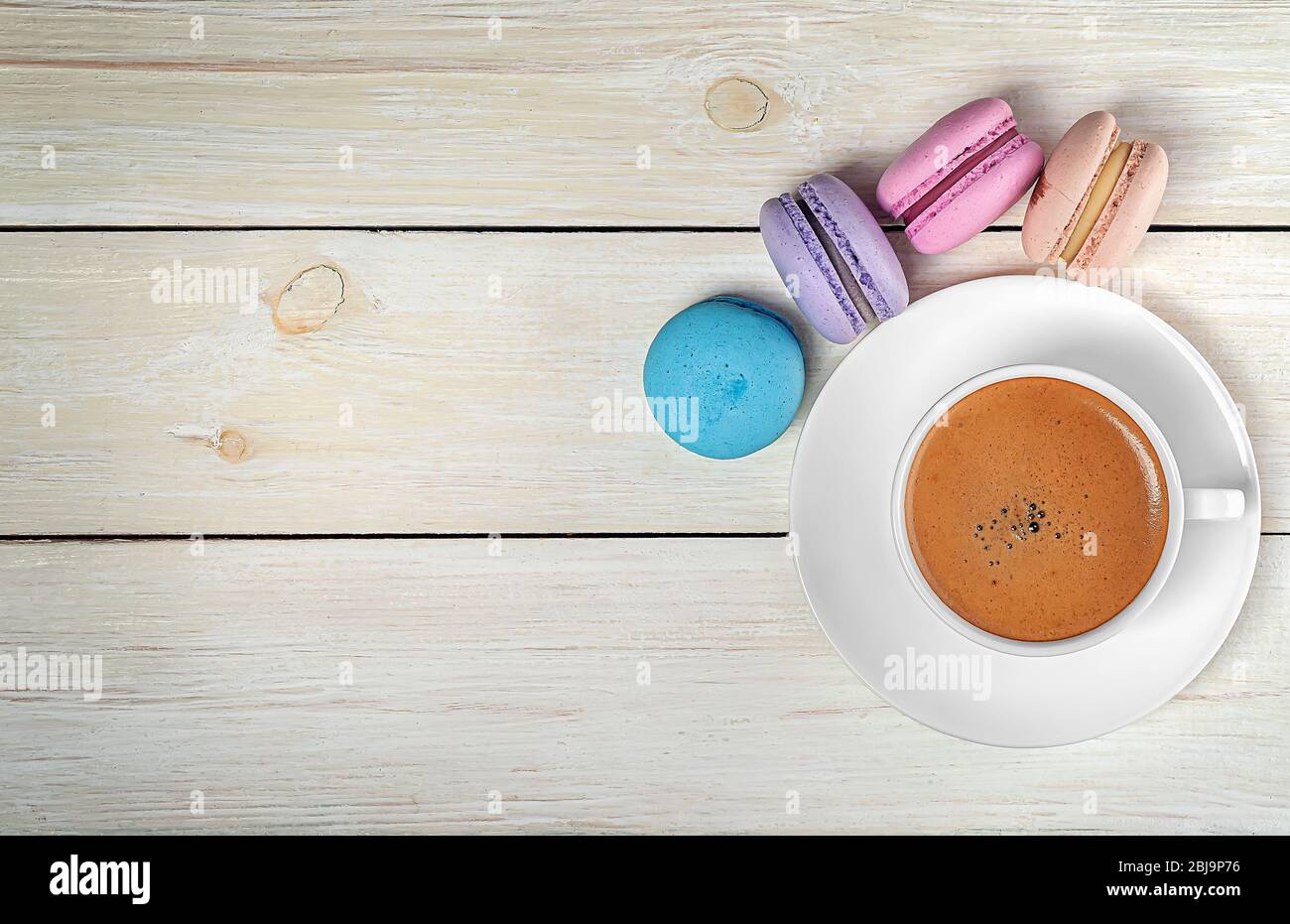 Macaroons and cup with coffee on top Stock Photo