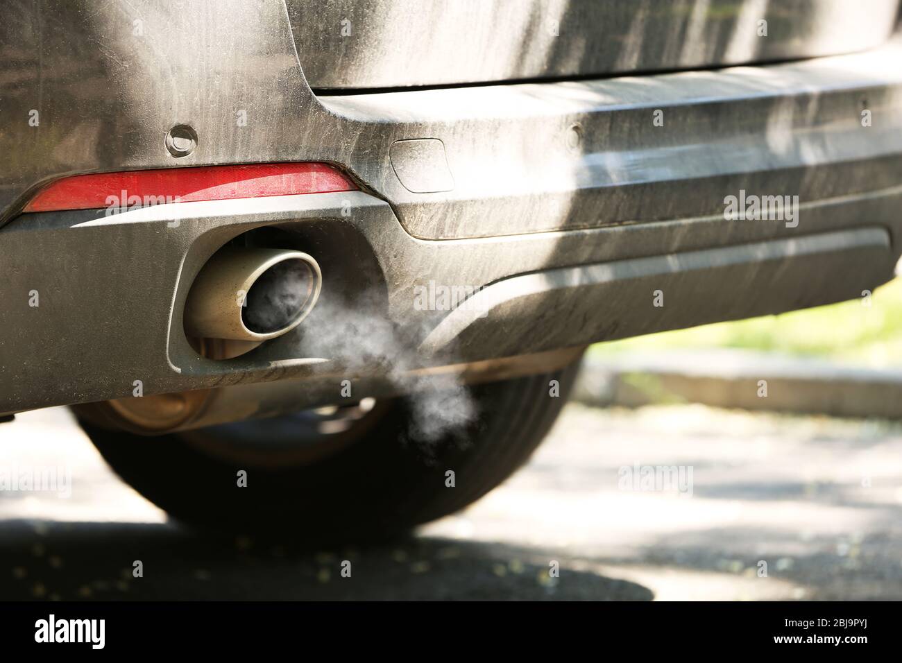 Combustion gas from car exhaust pipe, closeup Stock Photo