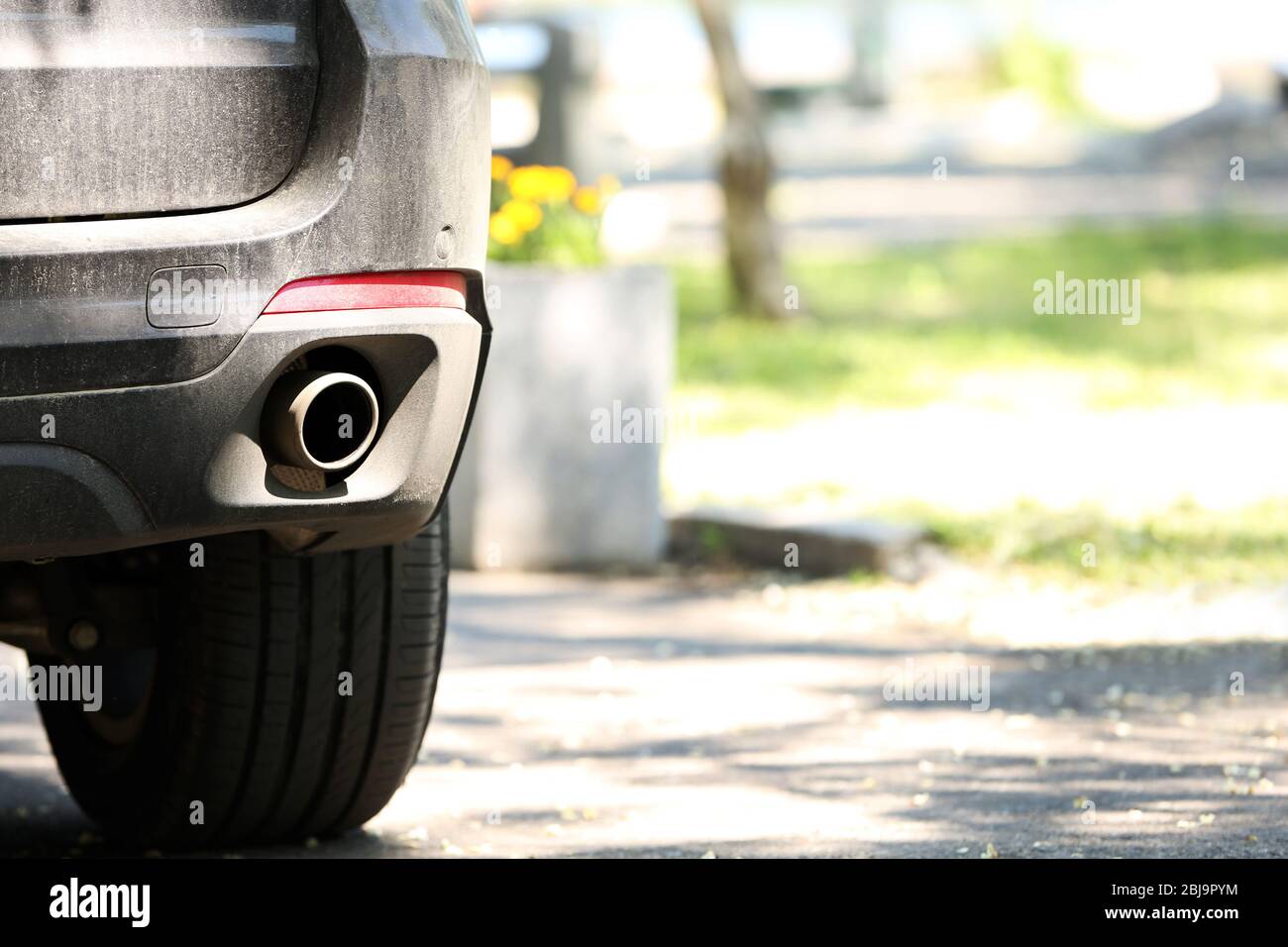Exhaust pipe and back part of a car Stock Photo - Alamy