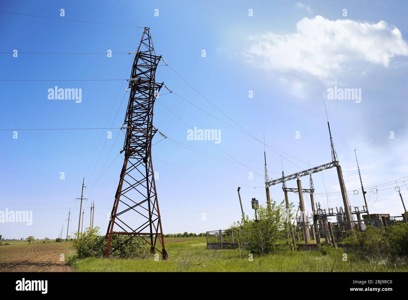 High voltage tower on blue sky background Stock Photo - Alamy