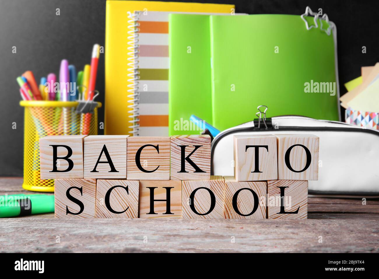 Words BACK TO SCHOOL and stationery set on table Stock Photo