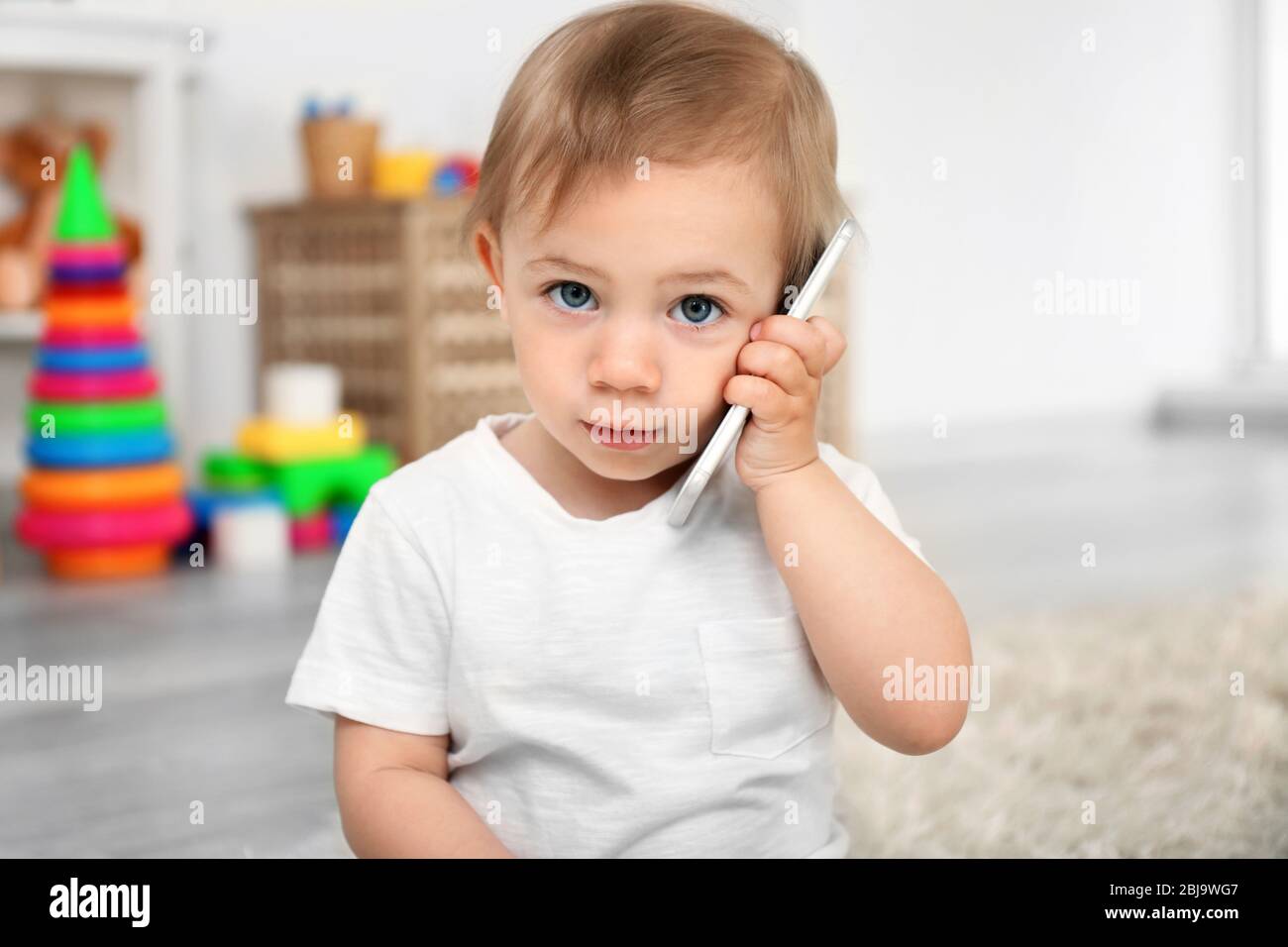 Baby Using Play Phone Cute baby girl playing with a smartphone Stock Photo - Alamy