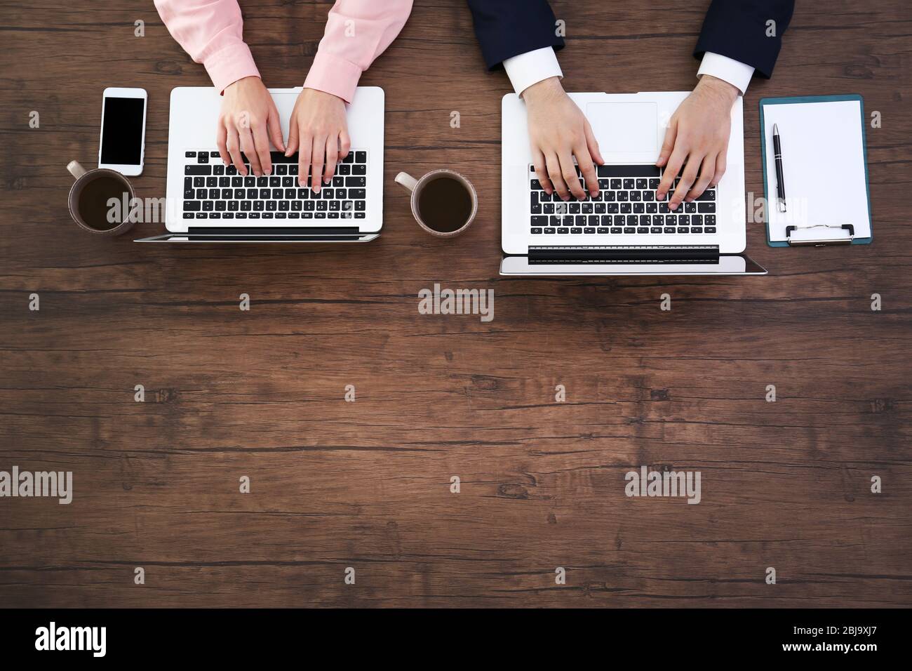 Laptops on desk office hands hi-res stock photography and images - Alamy