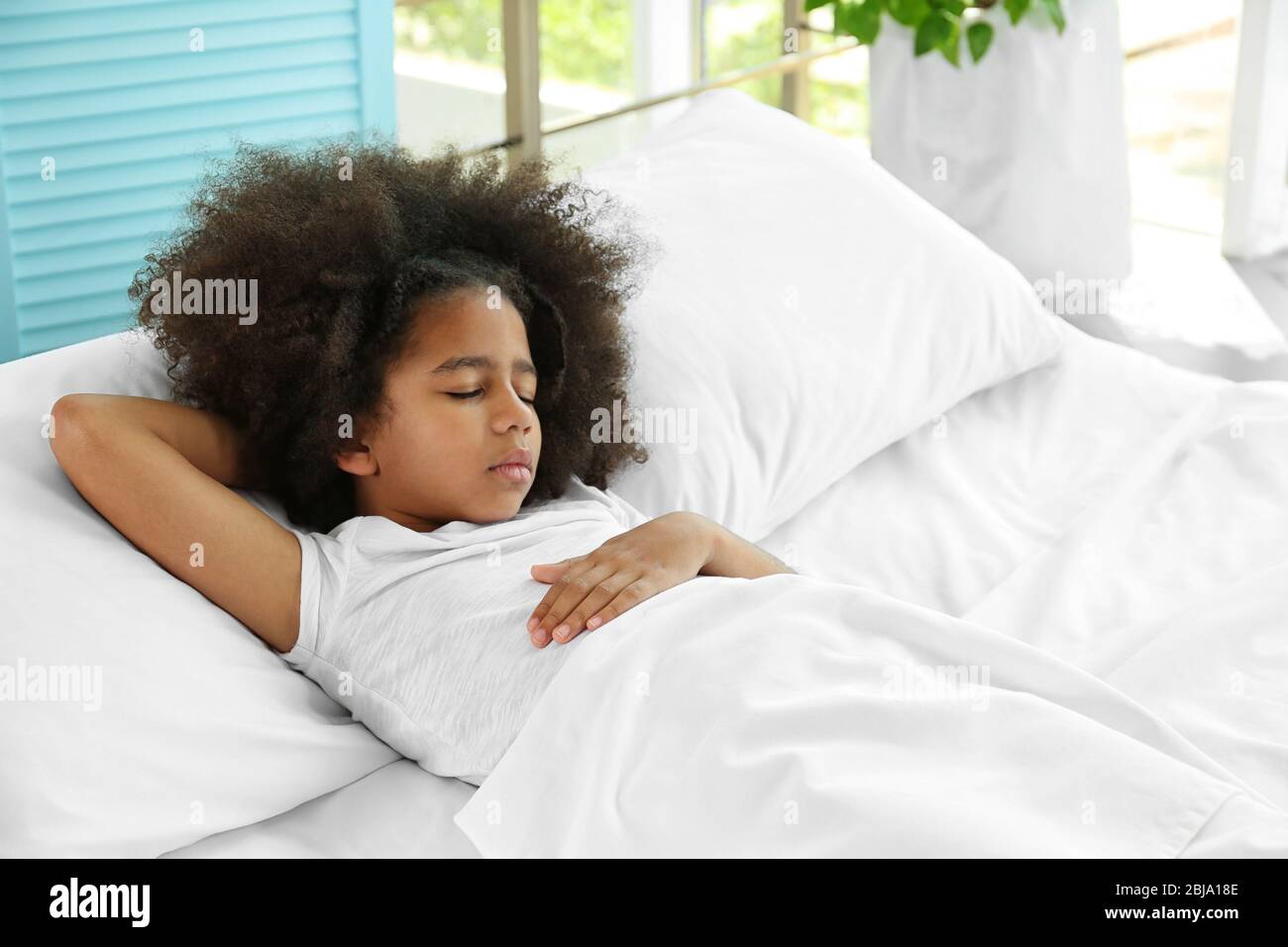 Cute African girl in bed Stock Photo - Alamy