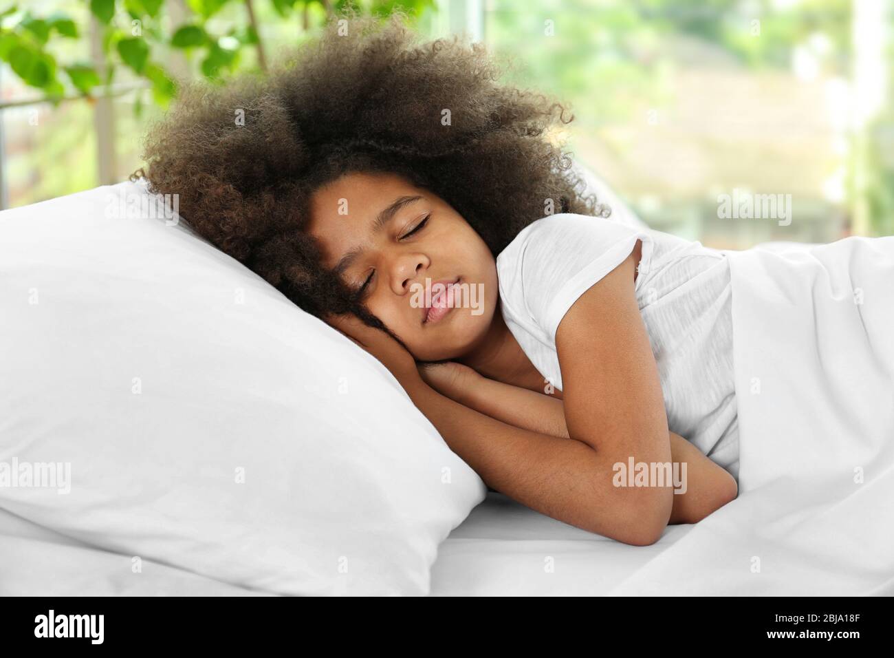 Cute African girl in bed Stock Photo - Alamy