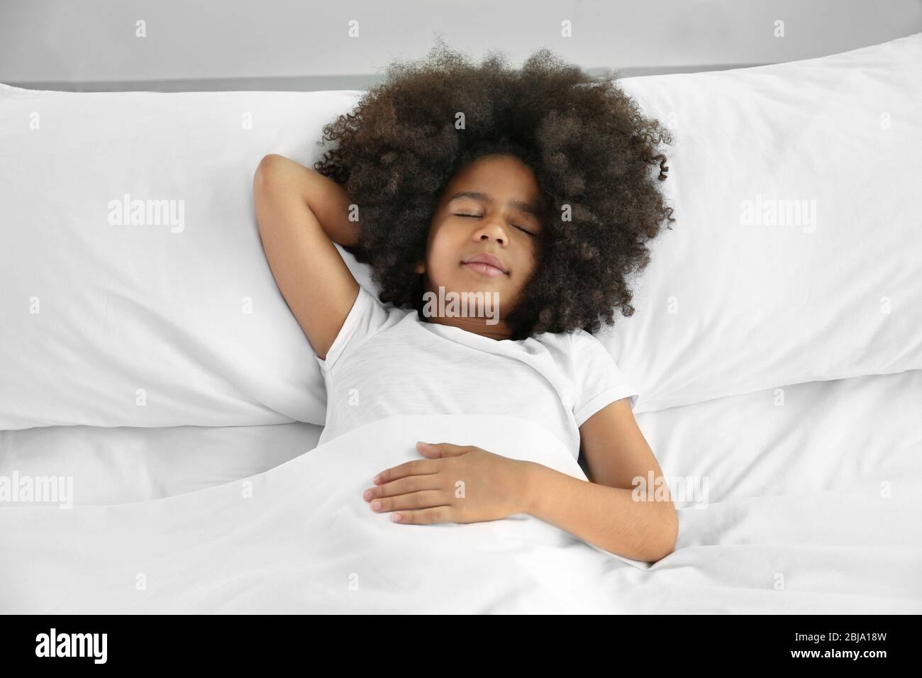 Cute African girl in bed Stock Photo - Alamy
