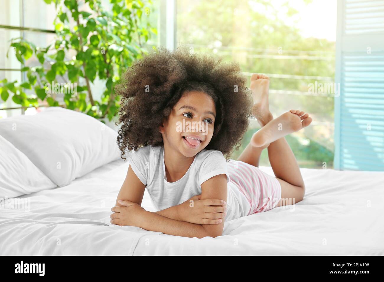 Cute African girl in bed Stock Photo - Alamy