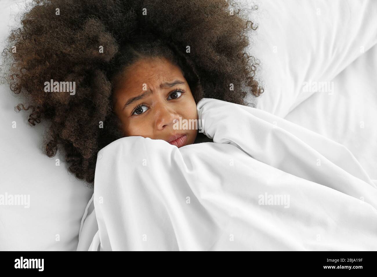 Cute African girl in bed Stock Photo - Alamy