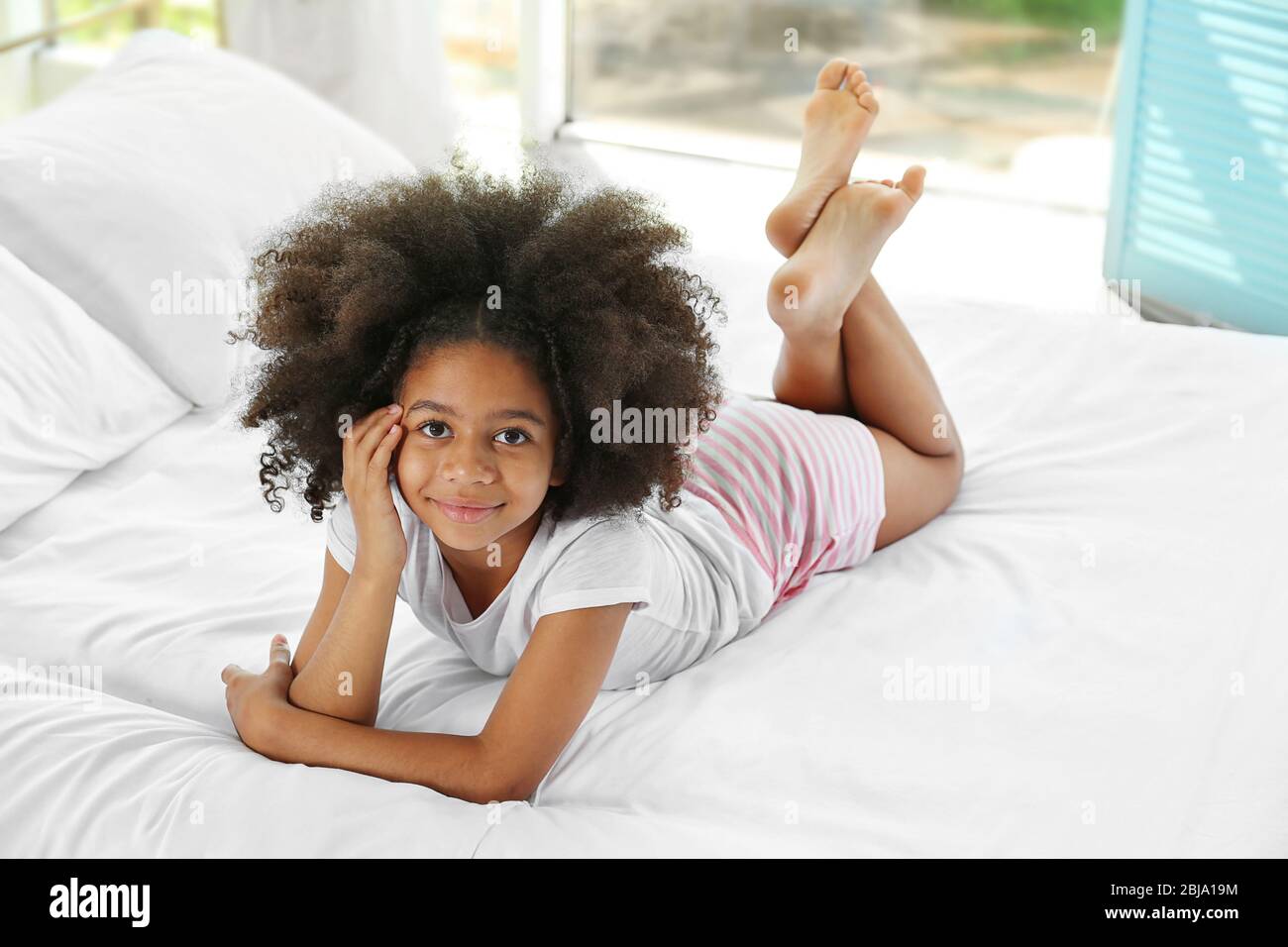 Cute African girl in bed Stock Photo - Alamy
