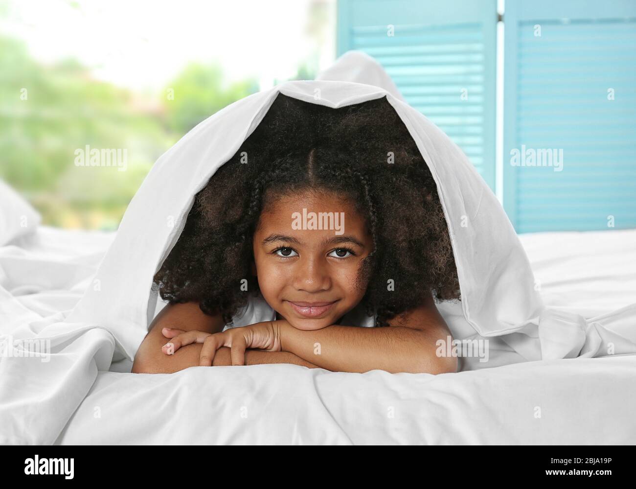 Cute African girl in bed Stock Photo - Alamy