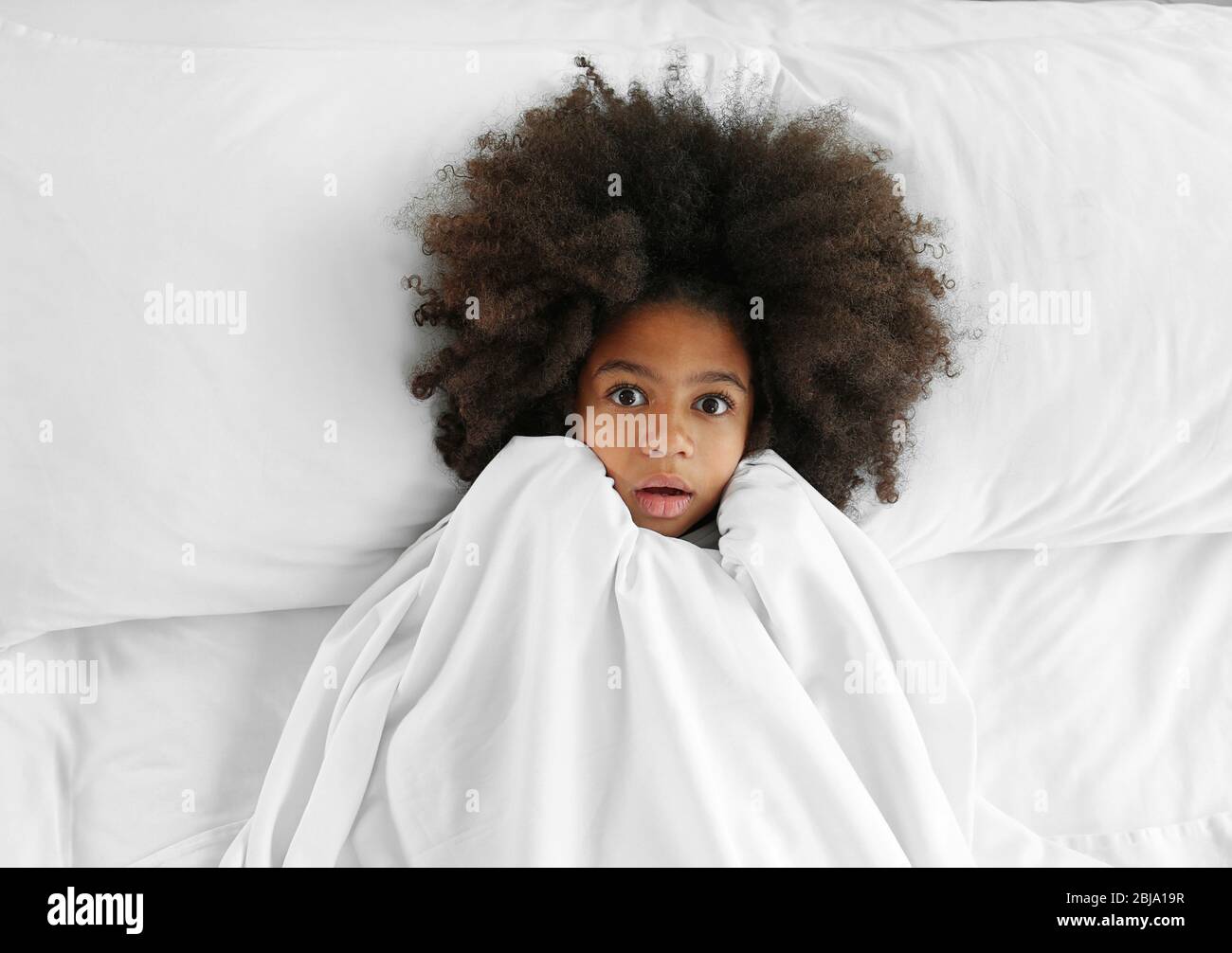 Cute African girl in bed Stock Photo - Alamy