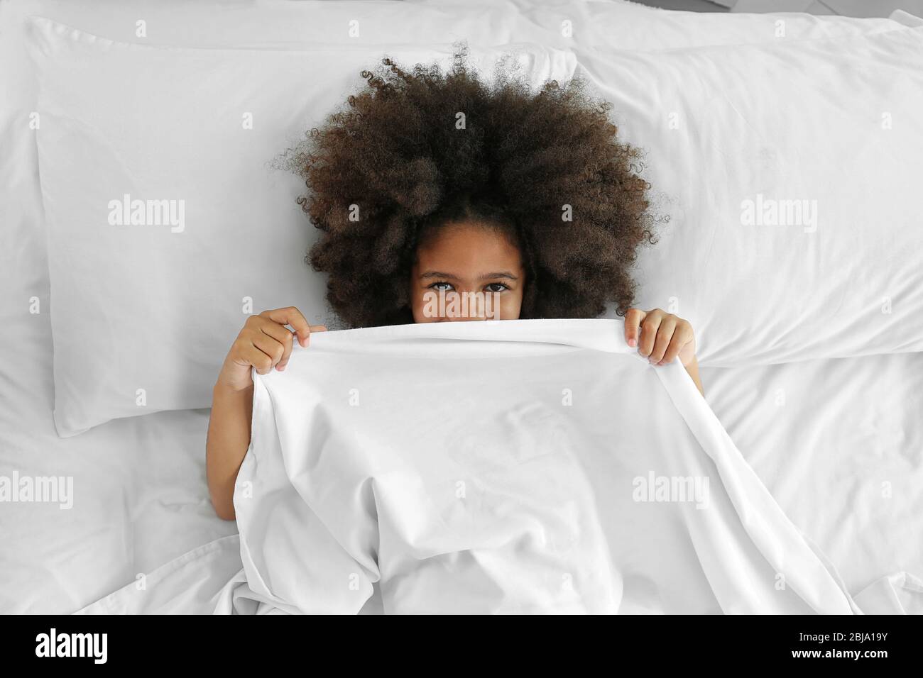 Cute African girl in bed Stock Photo - Alamy