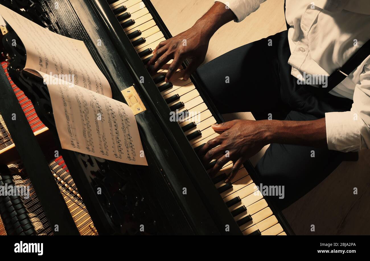 Man playing piano african american hi-res stock photography and images