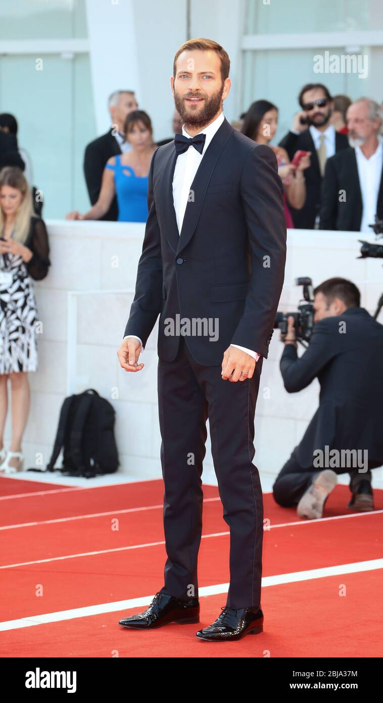 VENICE, ITALY - AUGUST 30: Alessandro Borghi walks the red carpet of the 'Downsizing' during the 74th Venice Film Festival on August 30, 2017 Stock Photo