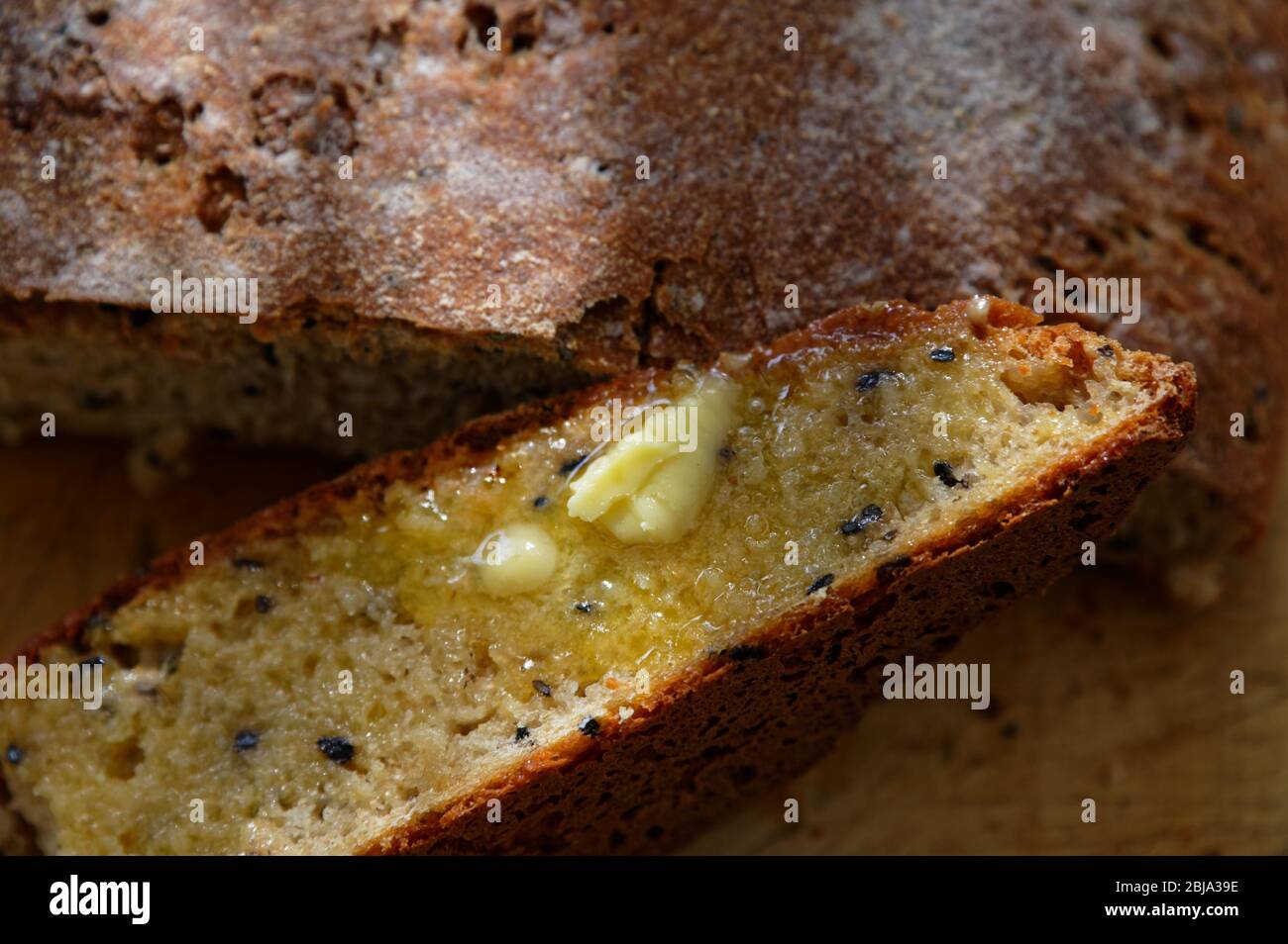 Buttered and ready to eat, a slice of bread that has just come out of