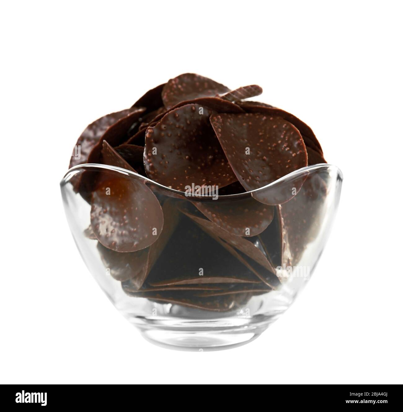 Chocolate chips in glass vase on white background Stock Photo Alamy