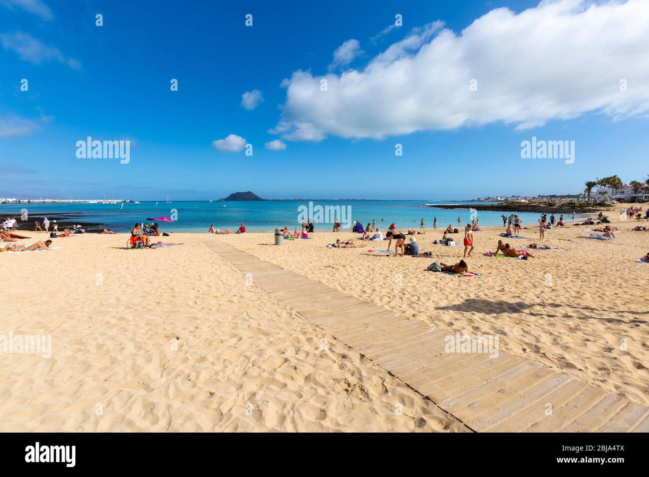 A sunny day with people sunbathing on the sand at Toro Beach, Fuerteventura, Spain Stock Photo
