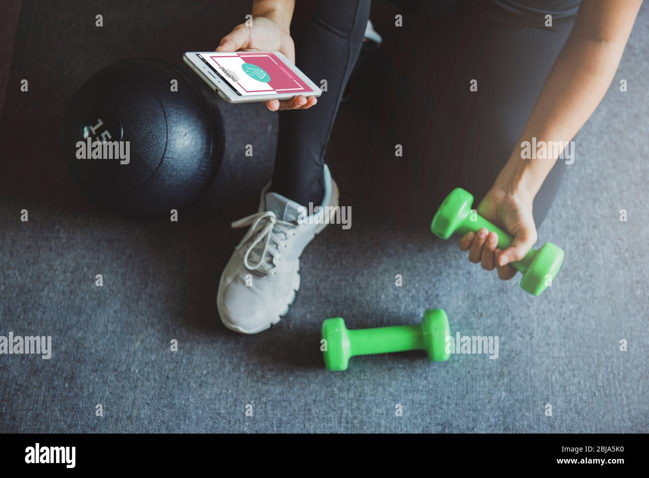 Young woman shopping online  while resting after workout at home.Online shopping and modern lifestyle concept.Copy space Stock Photo