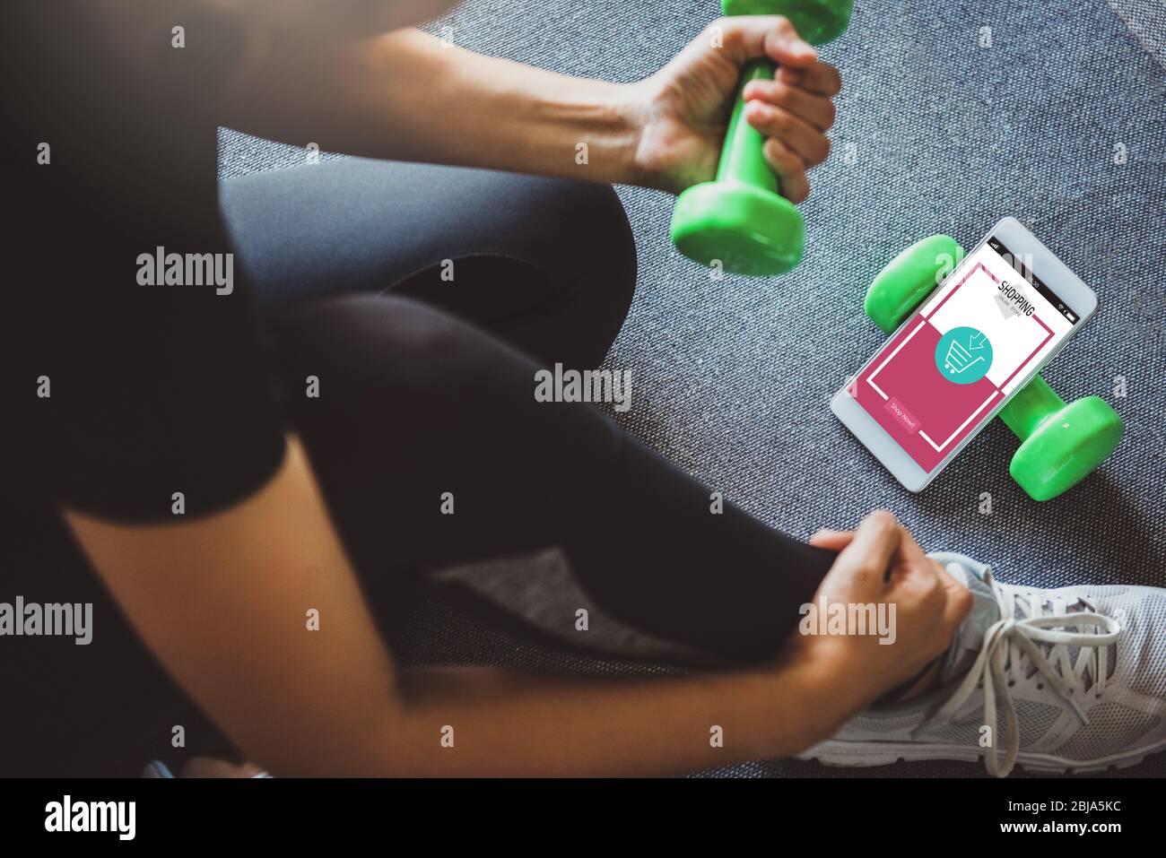 Online shopping and modern lifestyle concept: young woman shopping online  while resting after workout in fitness home. Stock Photo