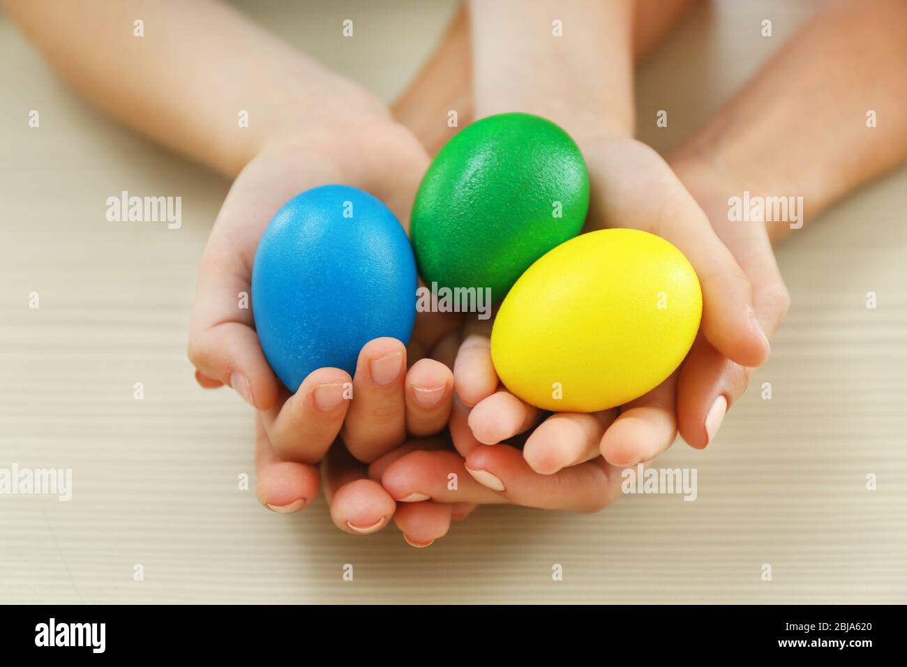 Mother and daughter holding Easter eggs Stock Photo
