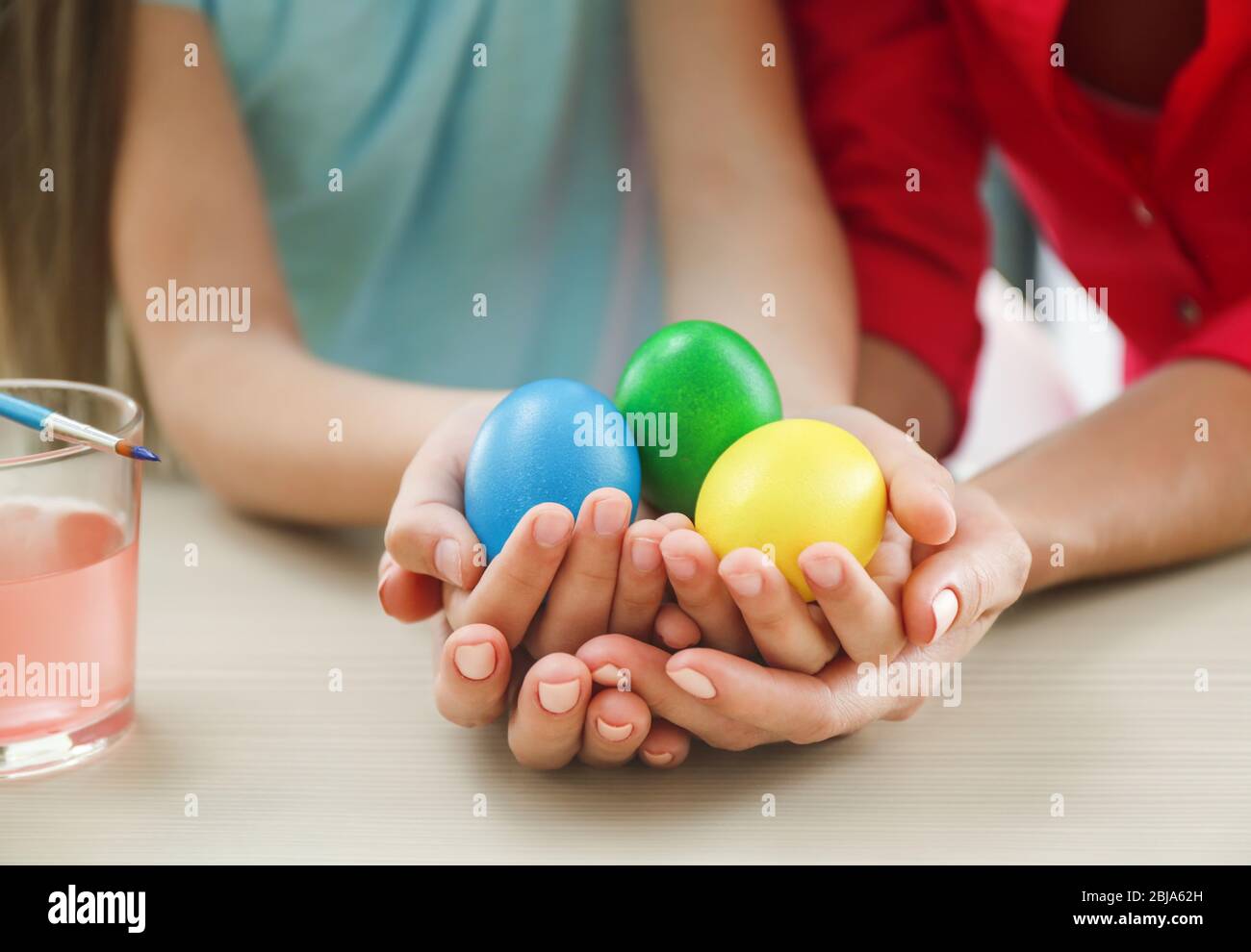 Mother and daughter holding Easter eggs Stock Photo