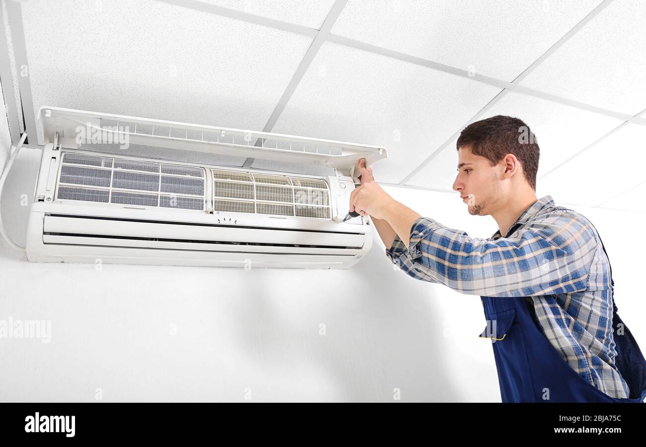 Technician repairing air conditioner on the wall Stock Photo Alamy