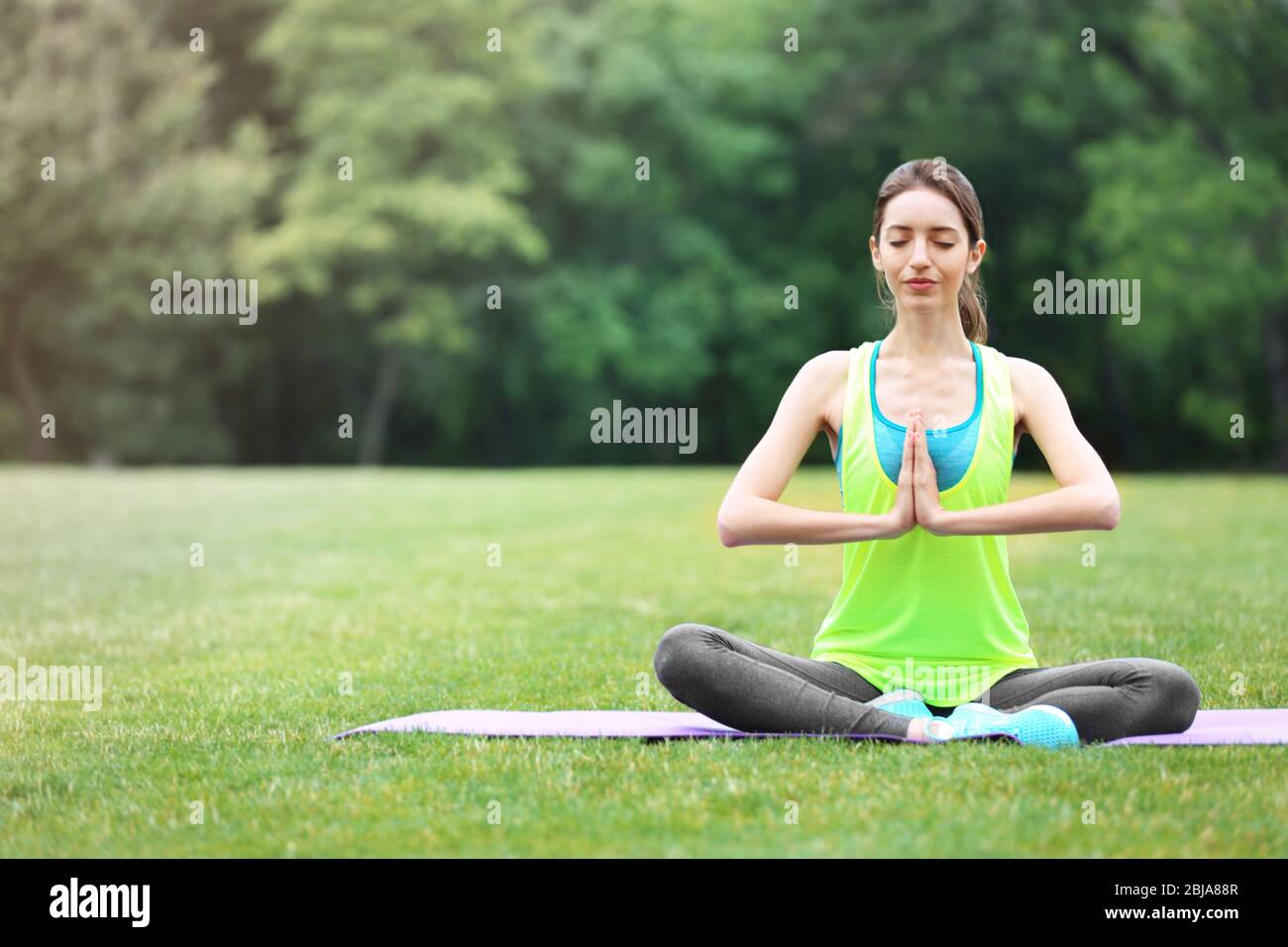 Woman meditating on mat in hi-res stock photography and images - Alamy