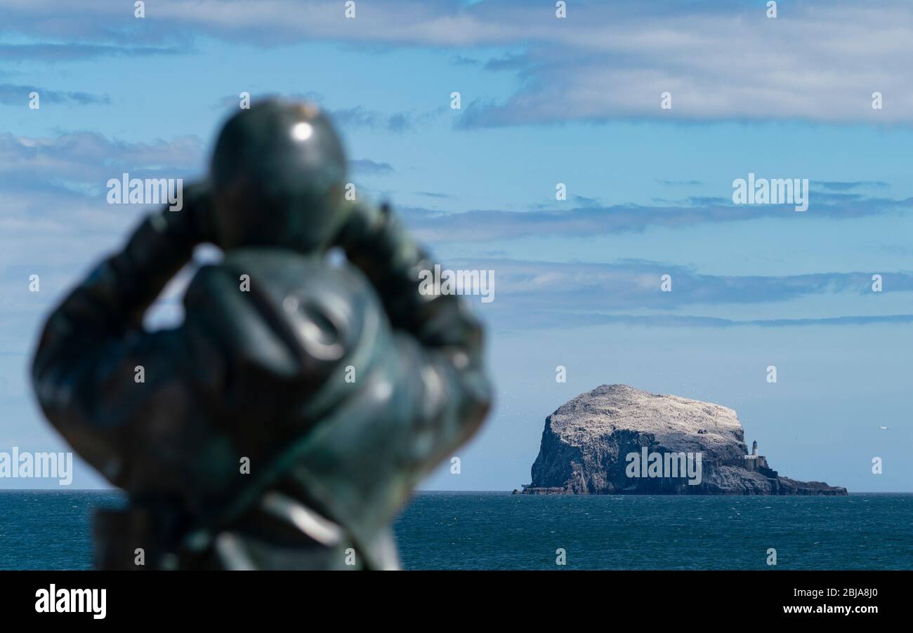 View of sculpture called The Watcher by Kenny Hunter and Bass Rock in Firth of Forth from North Berwick, East Lothian, Scotland, UK Stock Photo