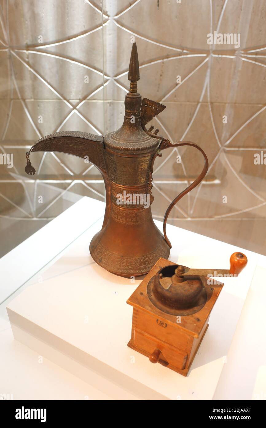 Traditional Arab coffee pot, dallah, and coffee grinder on display at the National Museum, Manama, Kingdom of Bahrain Stock Photo