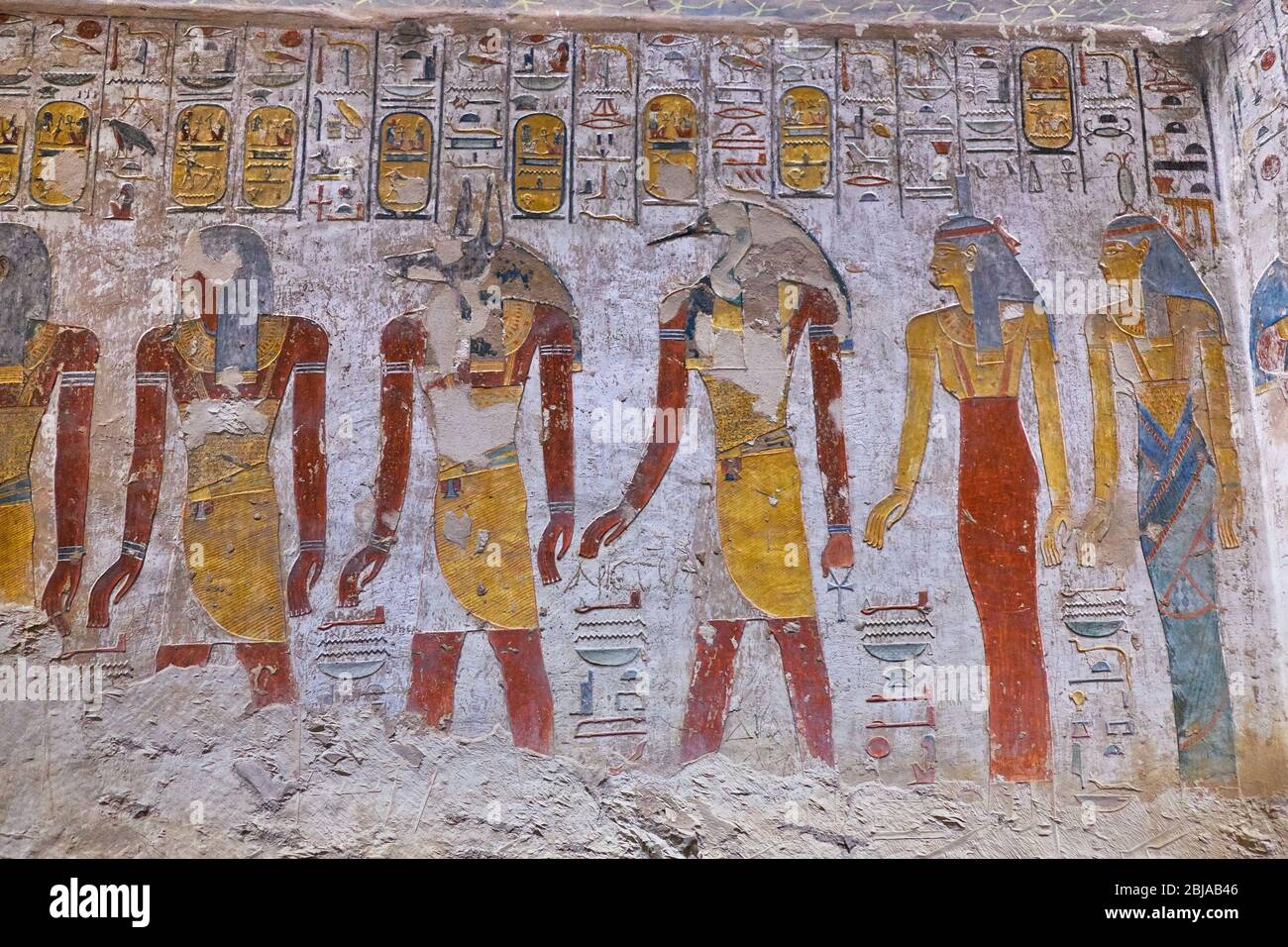 Ancient paintings and Egyptian hieroglyphs at the pharaoh tomb in the Valley of the Kings in Luxor, Egypt Stock Photo