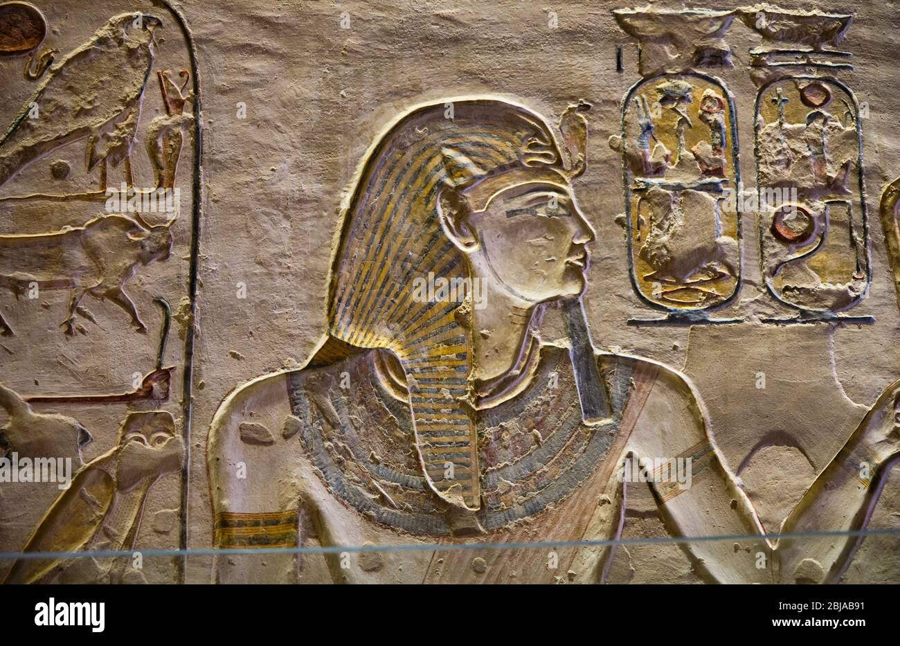 Ancient paintings and Egyptian hieroglyphs at the pharaoh tomb in the Valley of the Kings in Luxor, Egypt Stock Photo