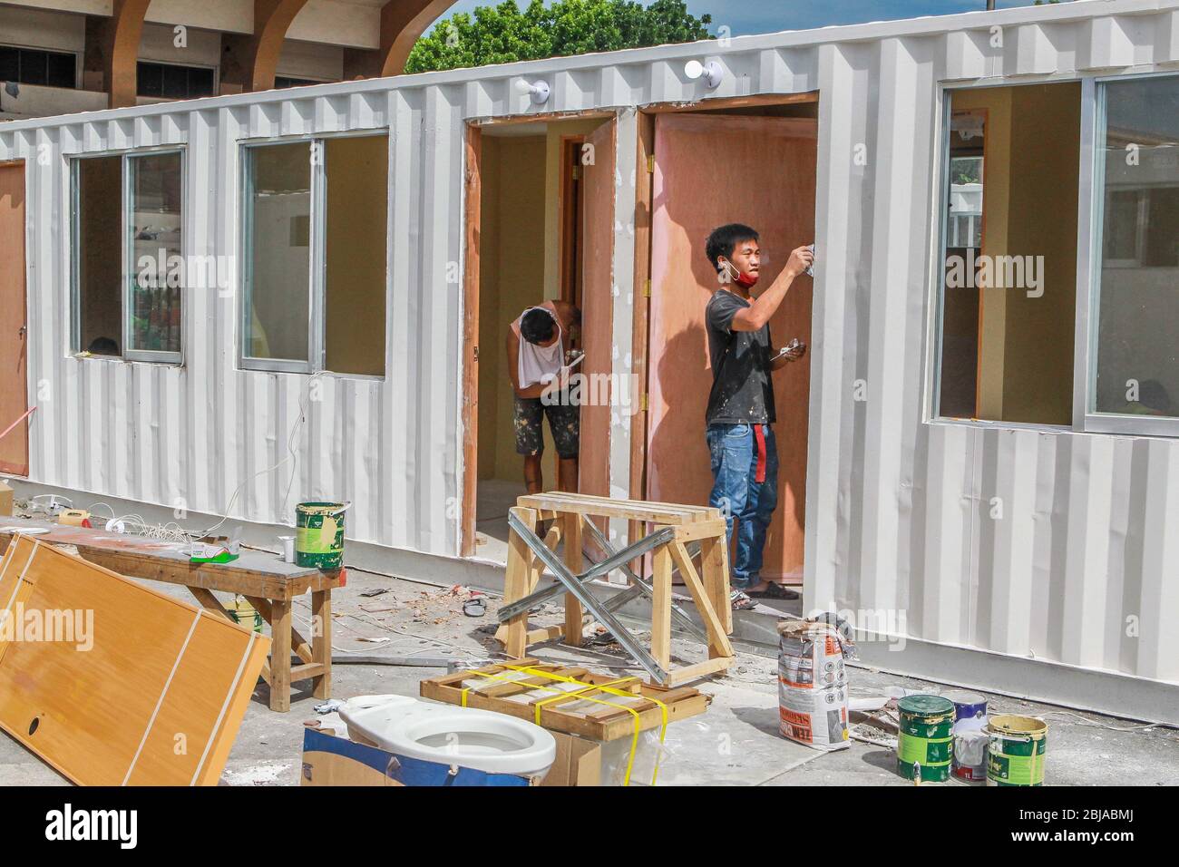 Manila, Philippines. 29th Apr, 2020. Workers from the Department of Public Works and Highways (DPWH) of the Philippines prepare containers that will be converted into temporary medical facilities in Manila, the Philippines, on April 29, 2020. Credit: Rouelle Umali/Xinhua/Alamy Live News Stock Photo
